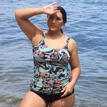 Woman in a patterned swimsuit standing by the water